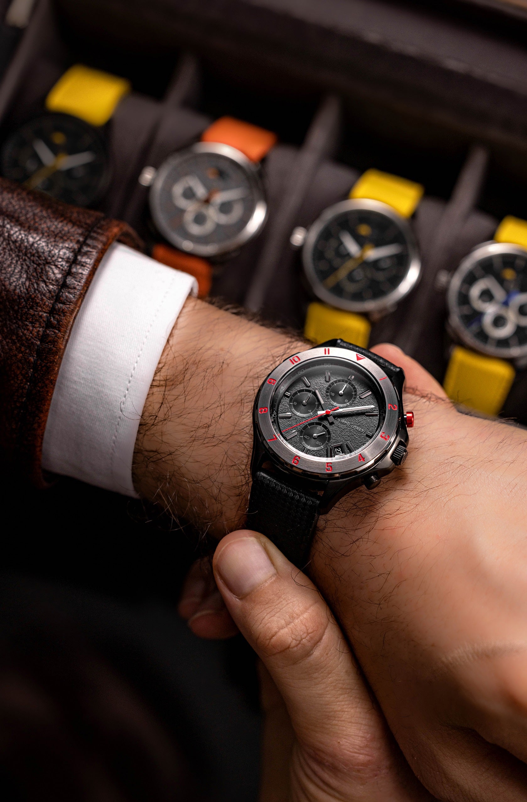 Pista Midnight Racer worn on the wrist beside a watch box