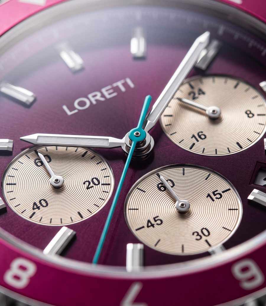 Close-up of the Ascari Mexico dial: plum dial, cream ringed subdials and a turquoise chronograph hand