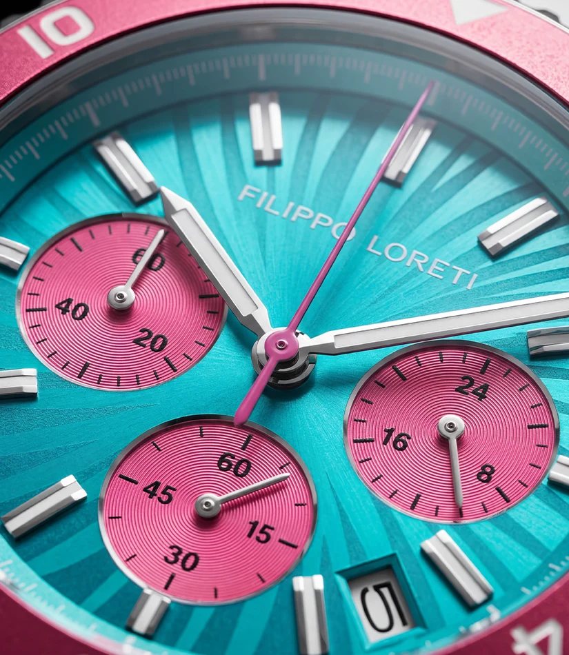 Close-up of the Ascari Miami dial: turquoise radiating pattern, pink subdials and the Filippo Loreti signature