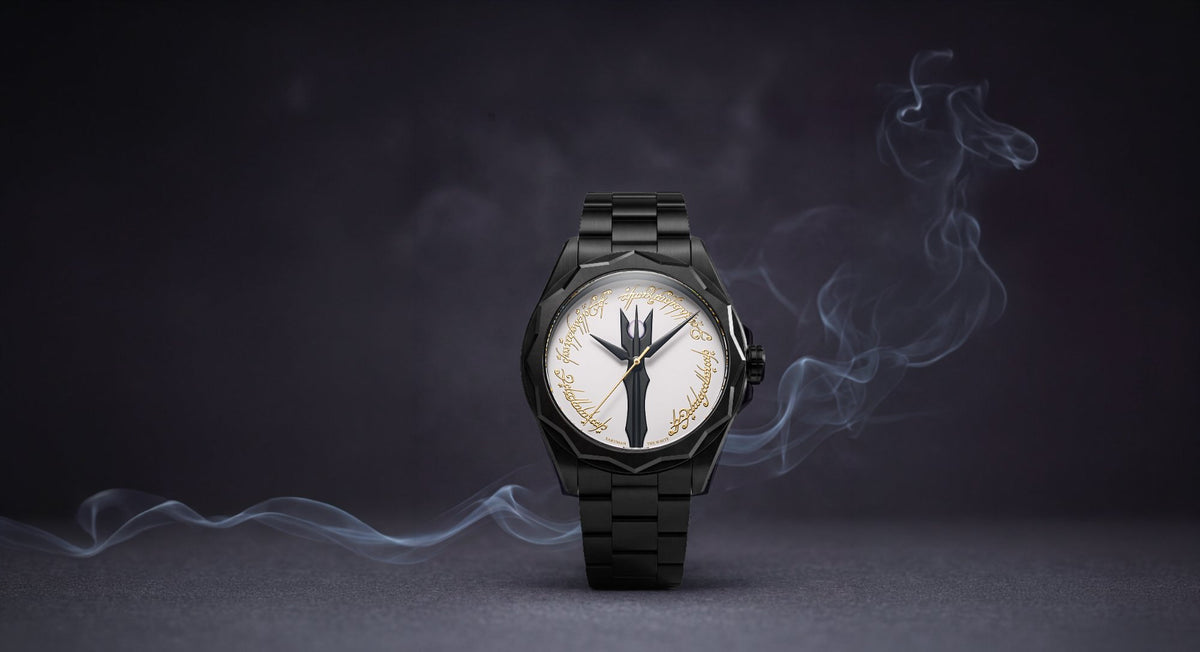 The Sauron watch on its black steel bracelet, the burning Eye dial ringed by Elvish script, standing in drifting smoke