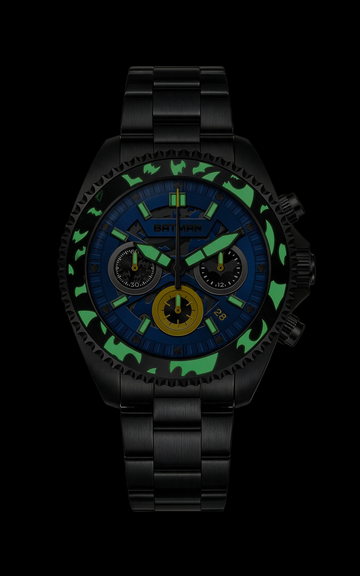 A black chronograph watch with a blue dial, green camouflage bezel, and yellow accents, shown against a solid black background.